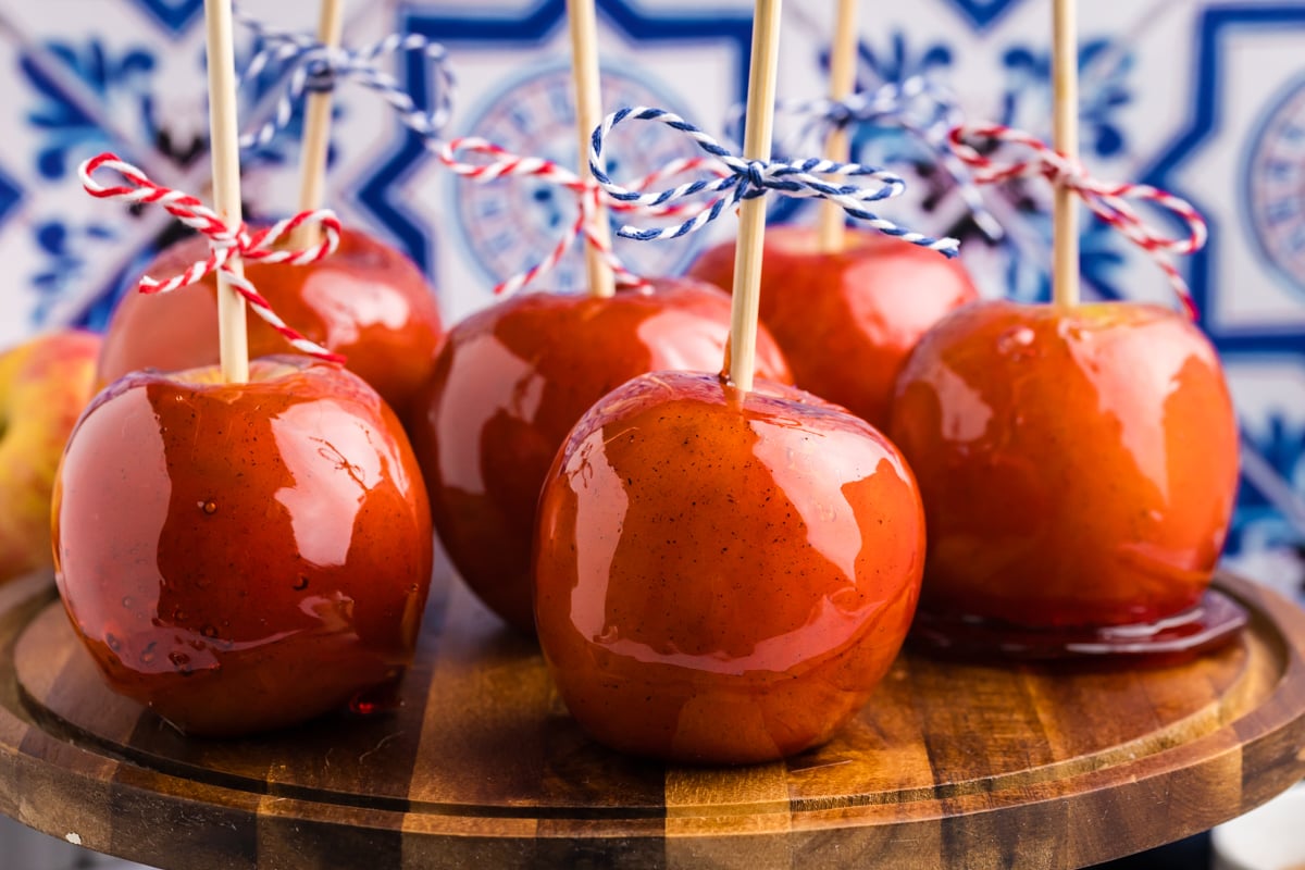 straight on shot of candy apples on wooden board