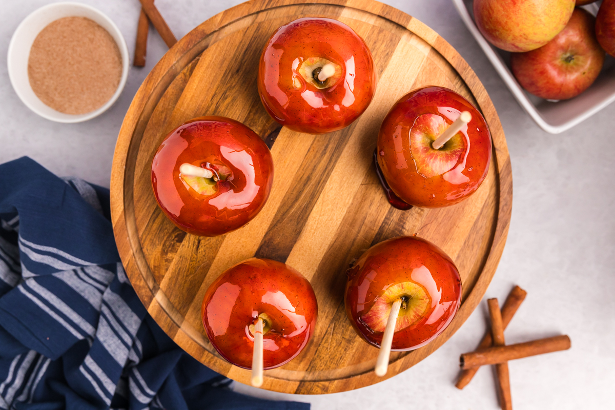 overhead shot of candied apples on wooden board