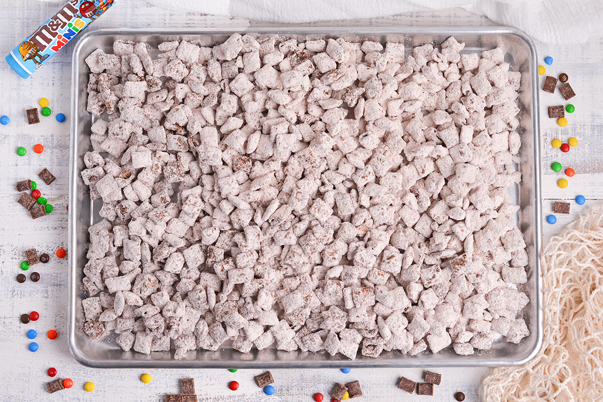 overhead shot of chocolate puppy chow on baking sheet