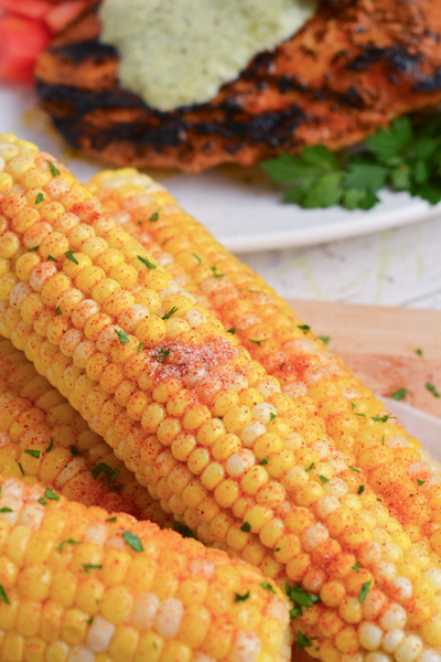 angled shot of seasoning on corn on the cob