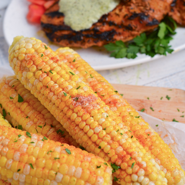 angled shot of seasoning on corn on the cob