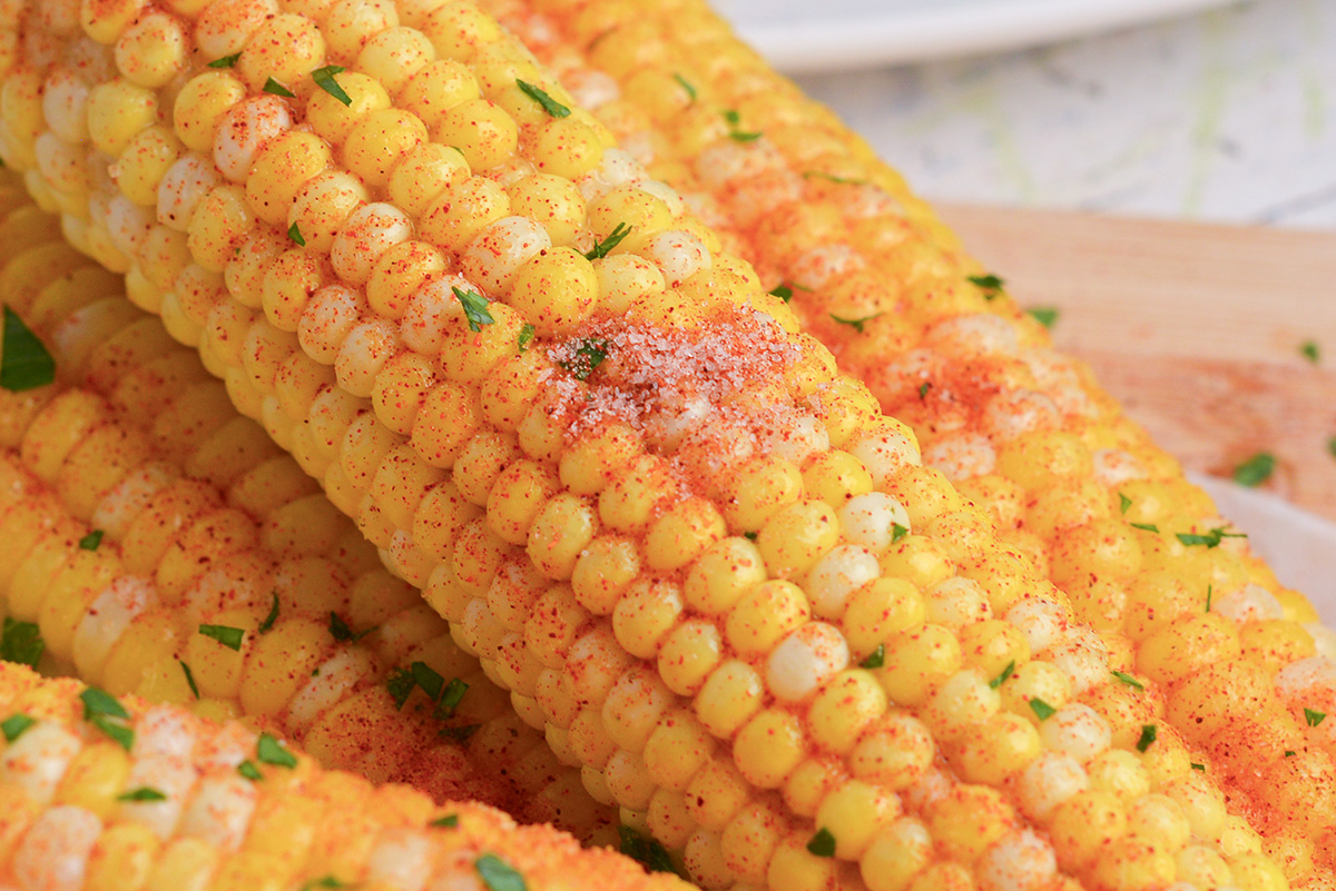 close up angled shot of seasoning on corn on the cob