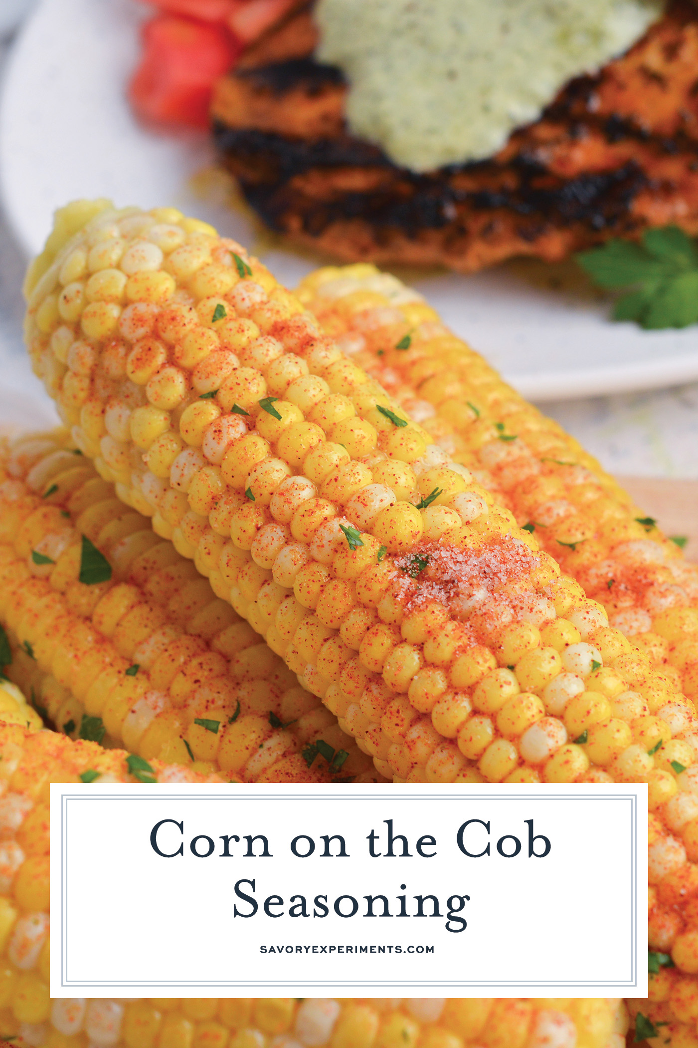 angled shot of seasoning on corn on the cob with text overlay