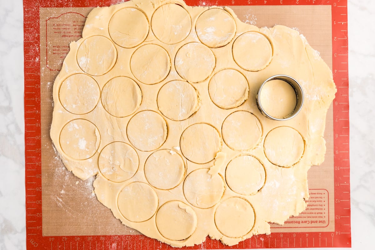 cookie cutter cutting circles in cookie dough