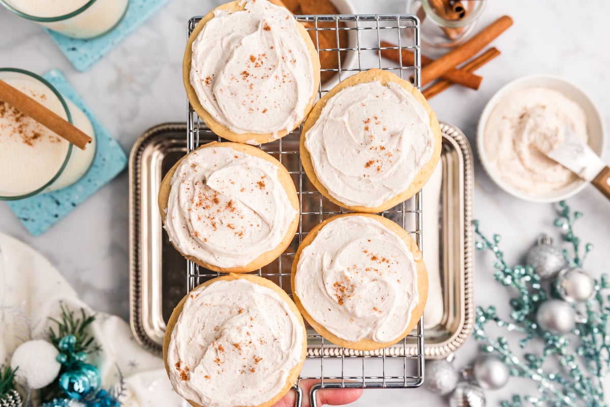 close up overhead shot of five eggnog cookies on wire tray