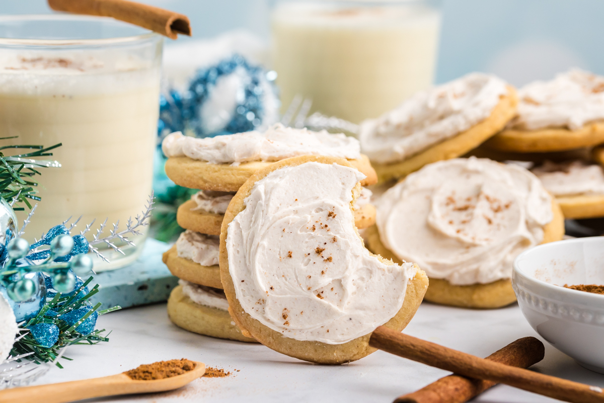 straight on shot of stack of eggnog cookies with bite taken out of one