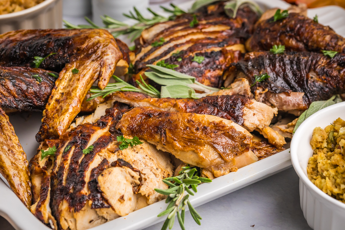 angled shot of sliced fried turkey on baking sheet