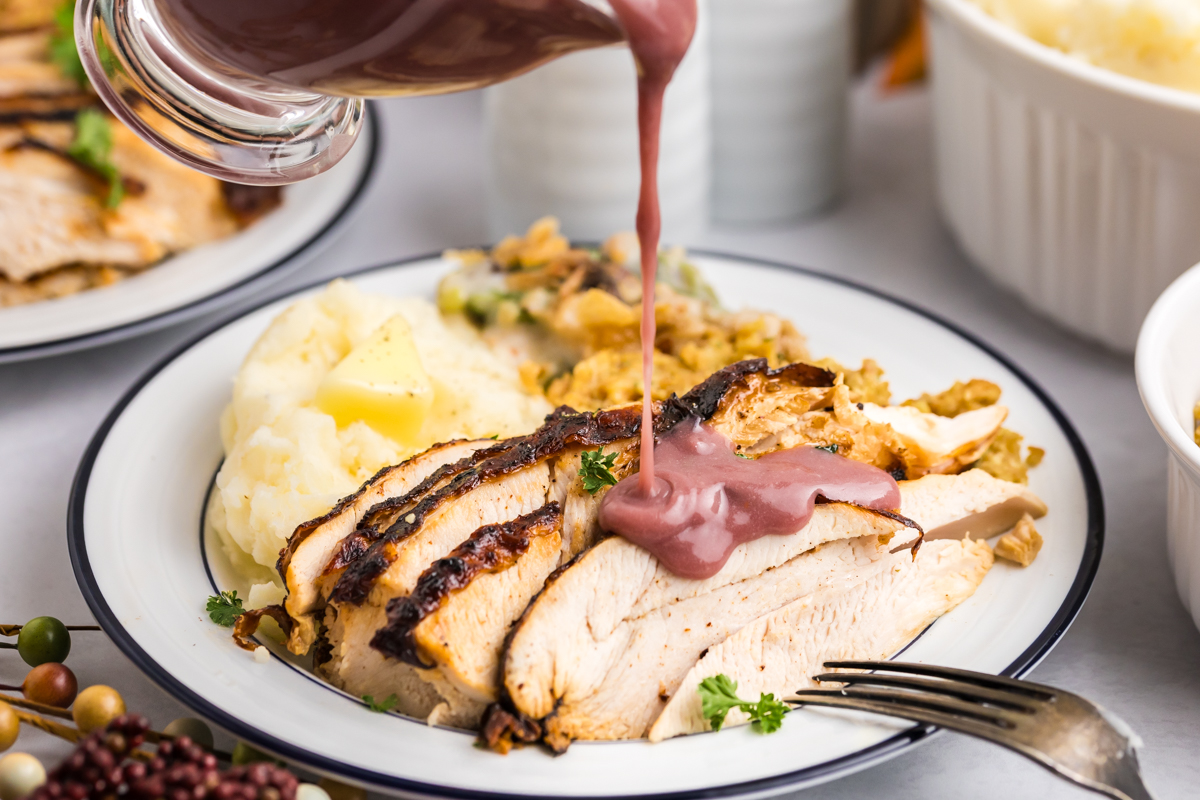 gravy pouring over sliced turkey on plate