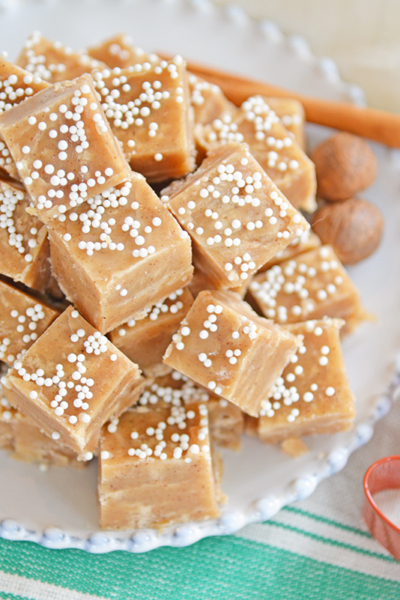 Gingerbread fudge squares on a white plate with red gingerbread man cookie cutter