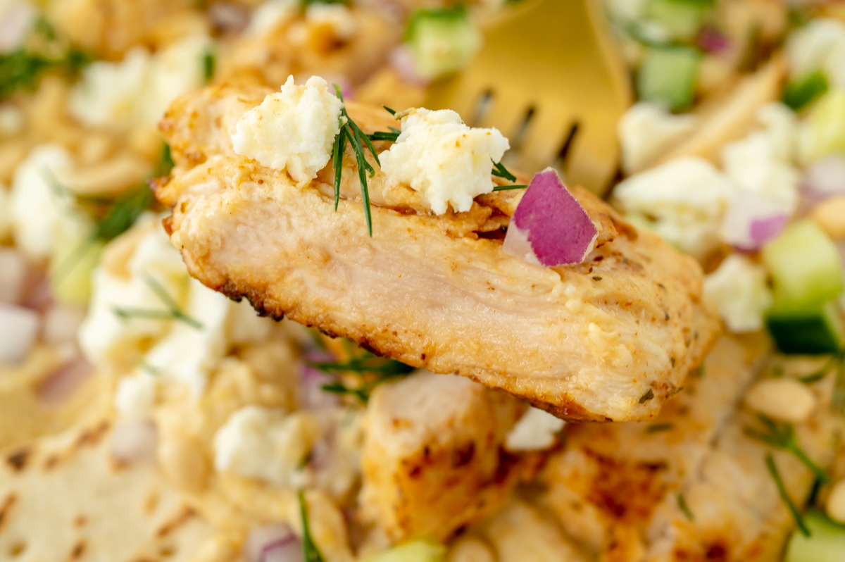 close up of bite of chicken on fork