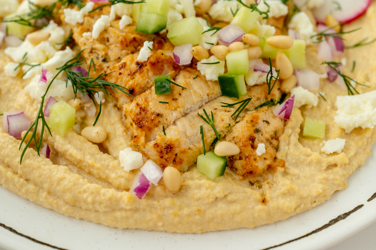 angled shot of greek chicken hummus bowl