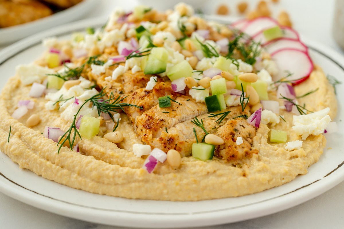 straight on shot of greek chicken hummus bowl