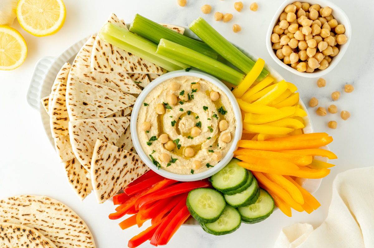 overhead shot of platter of hummus and veggies