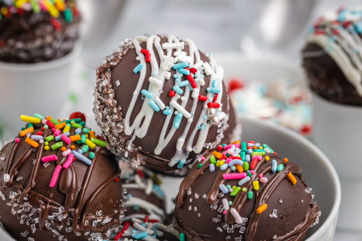 close up angled shot of bowl of hot chocolate bombs