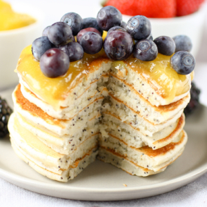 bite taken out of stack of lemon poppyseed pancakes