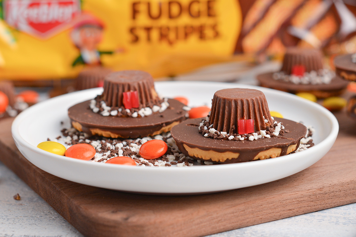 two pilgrim hat cookies on a plate