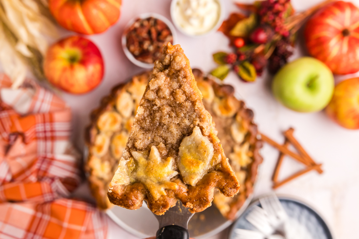 overhead shot of slice of pumpkin apple pie on spatula