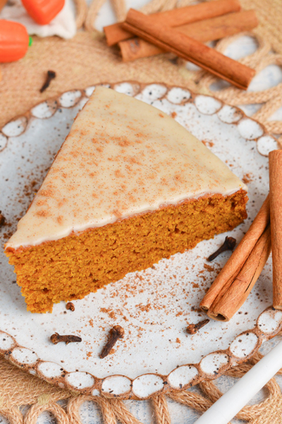 angled shot of slice of pumpkin olive oil cake on plate