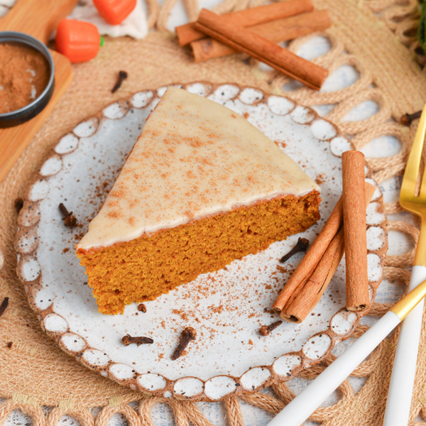 angled shot of slice of pumpkin olive oil cake on plate