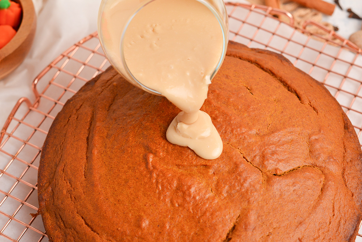 maple glaze poured over pumpkin cake