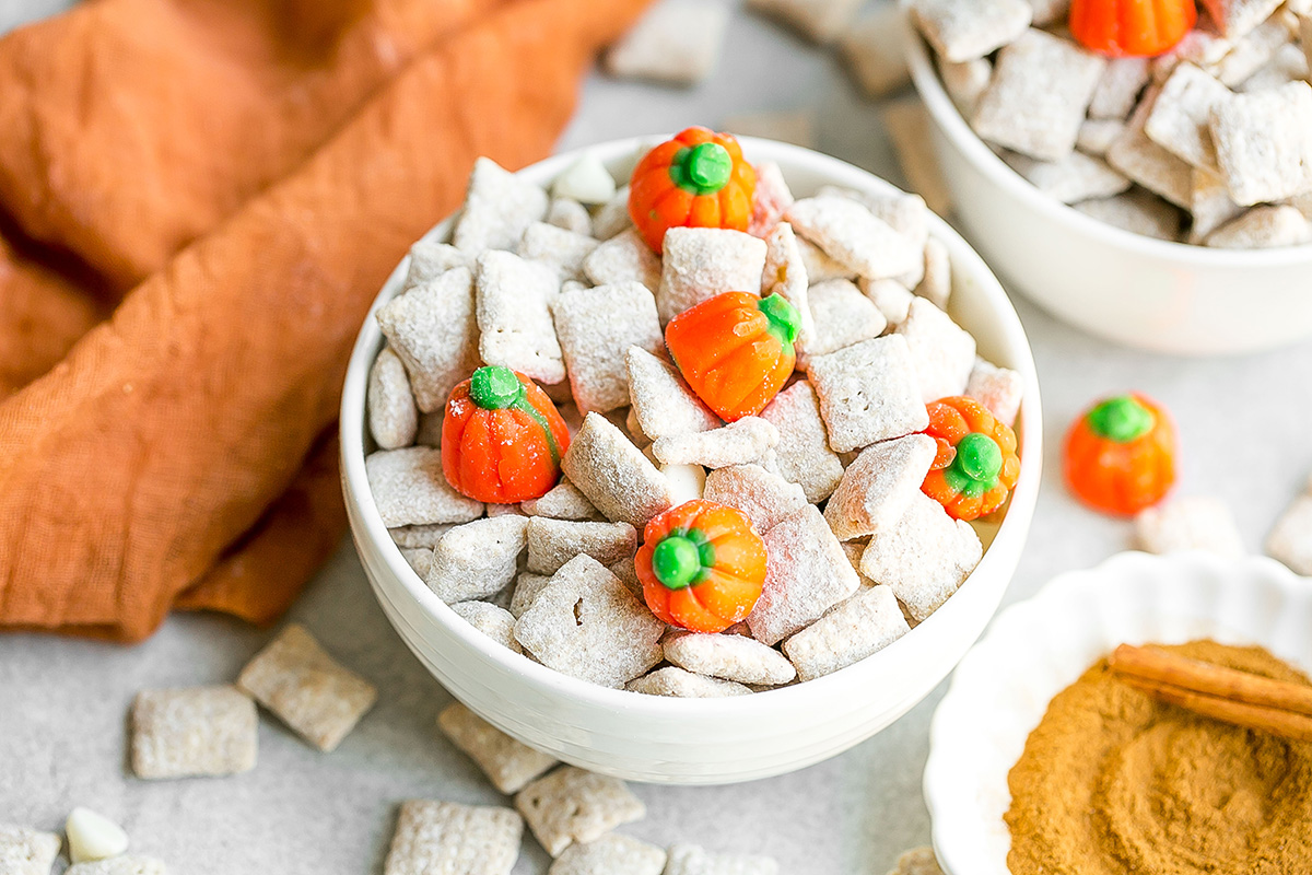 angled shot of pumpkin spice puppy chow in white bowl