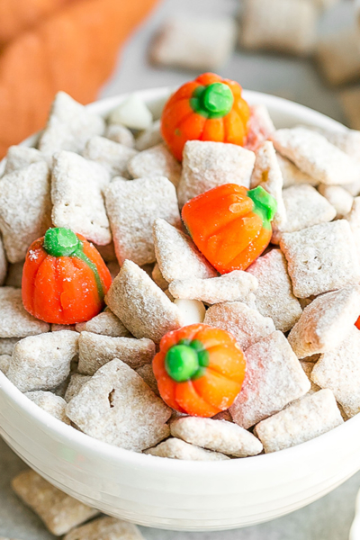 angled shot of white bowl of pumpkin spice puppy chow