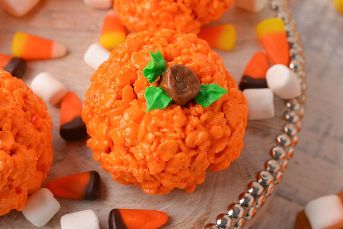 close up shot of pumpkin rice krispie treats on a tray