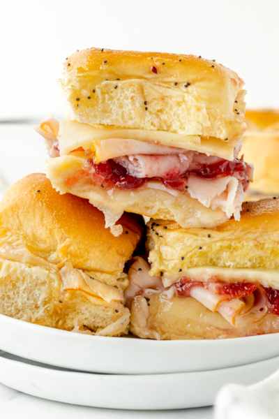 straight on shot of stack of cranberry turkey sliders on a plate