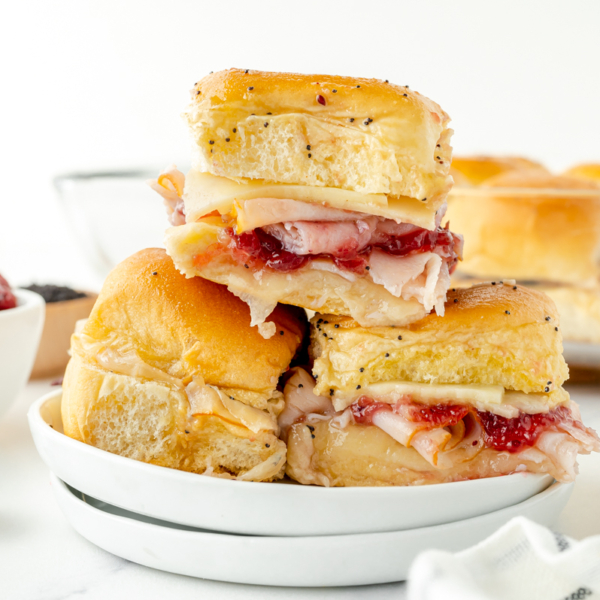 straight on shot of stack of cranberry turkey sliders on a plate