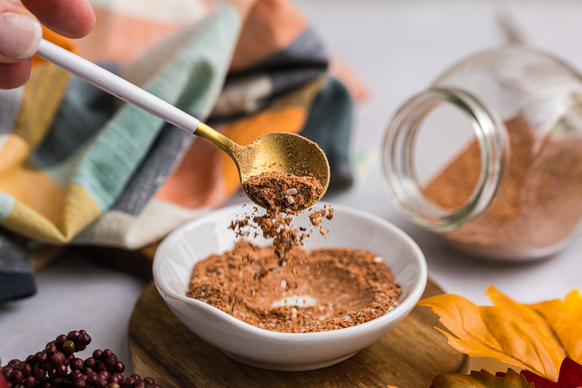 spoon dropping turkey seasoning into bowl