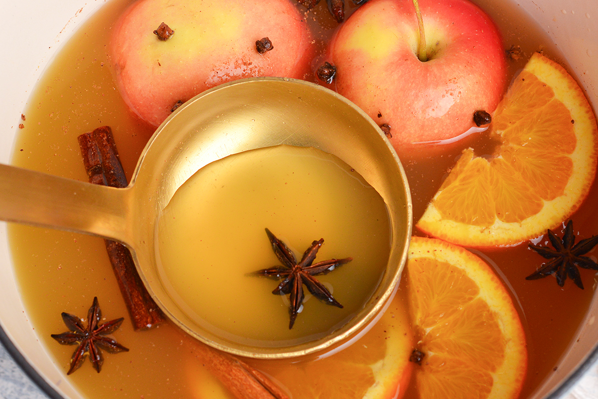 angled shot of ladle in pot of wassail