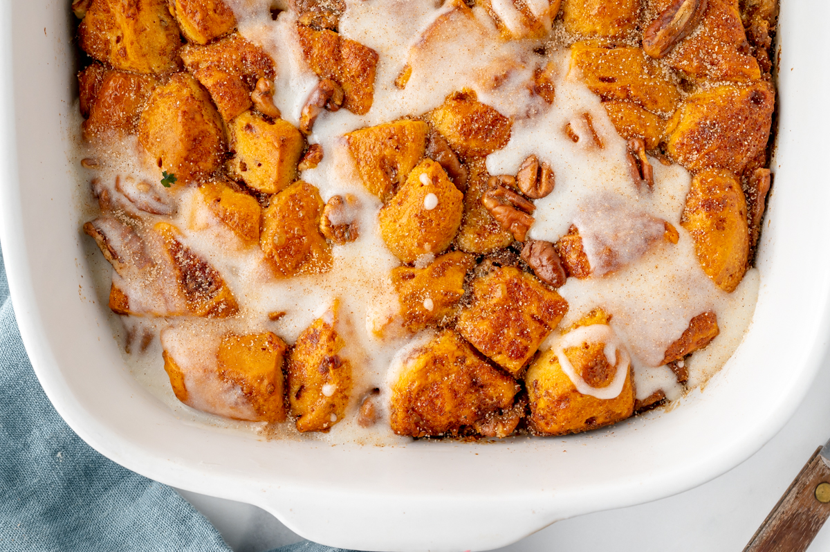 overhead half shot of cinnamon roll casserole in baking dish