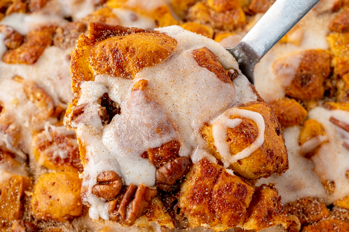 angled shot of serving spoon in cinnamon roll casserole