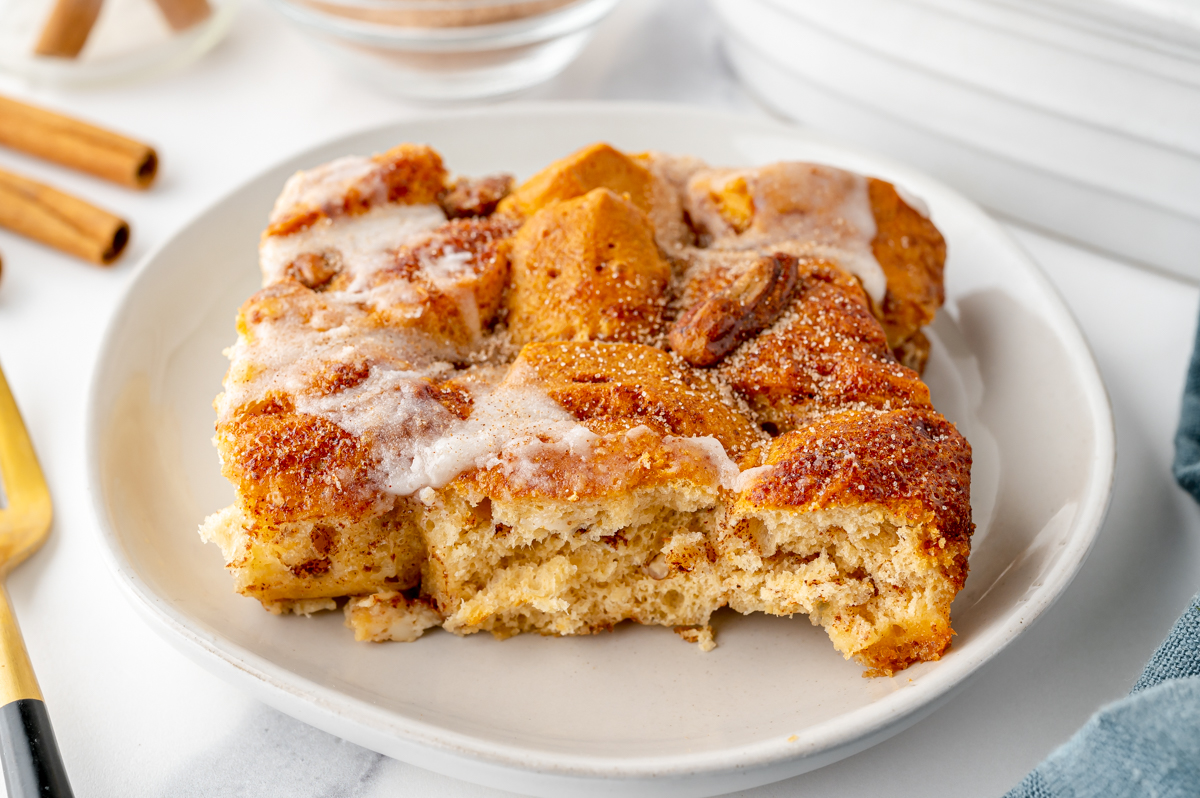 angled shot of slice of cinnamon roll casserole on plate