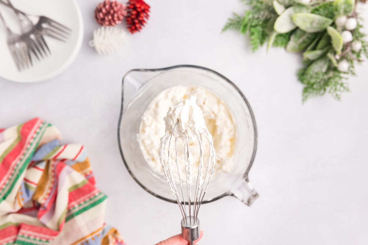 overhead shot of whipped cream on whisk