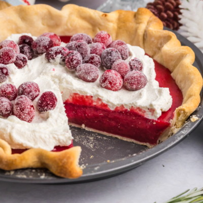 angled shot of slice taken out of cranberry pie