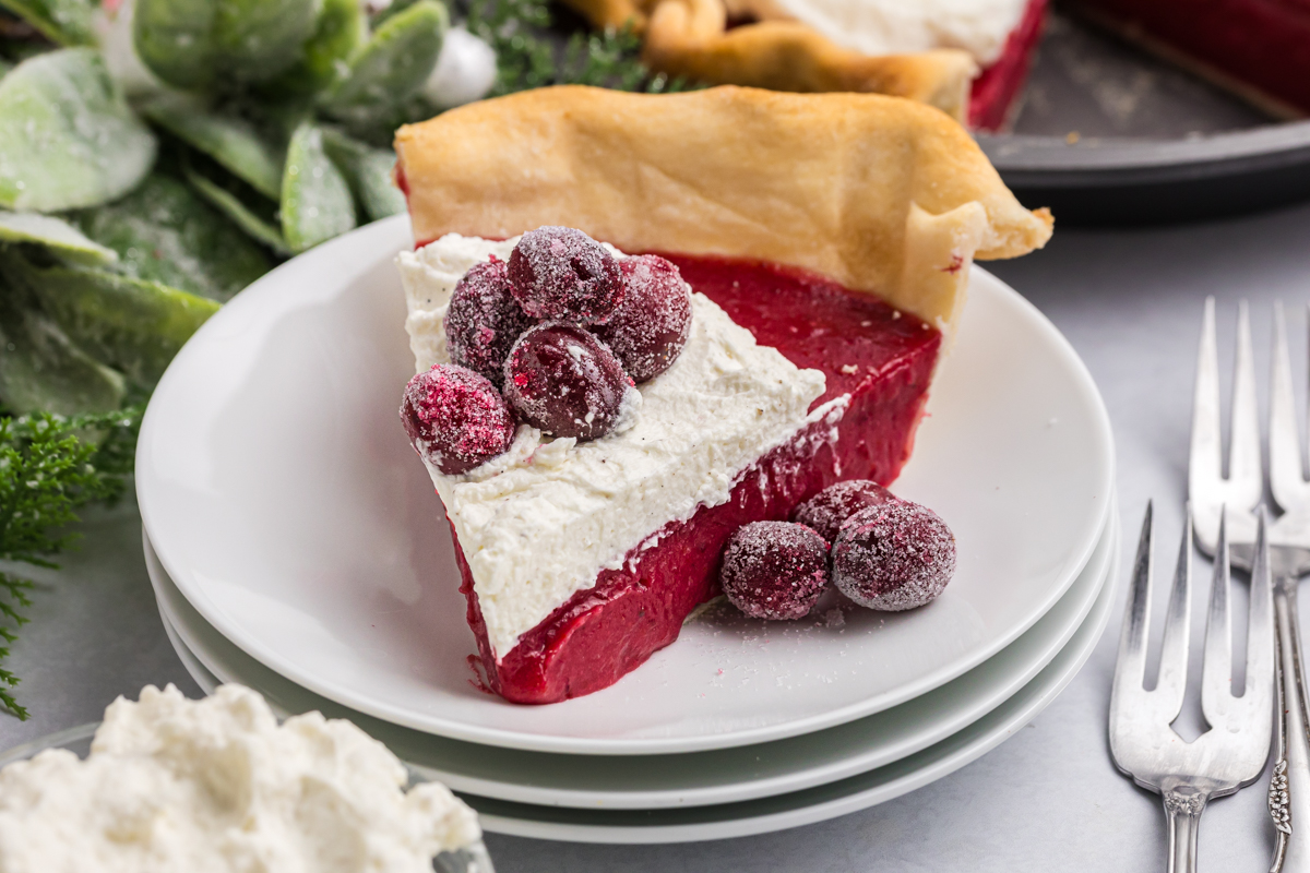 close up angled shot of slice of cranberry pie on plate