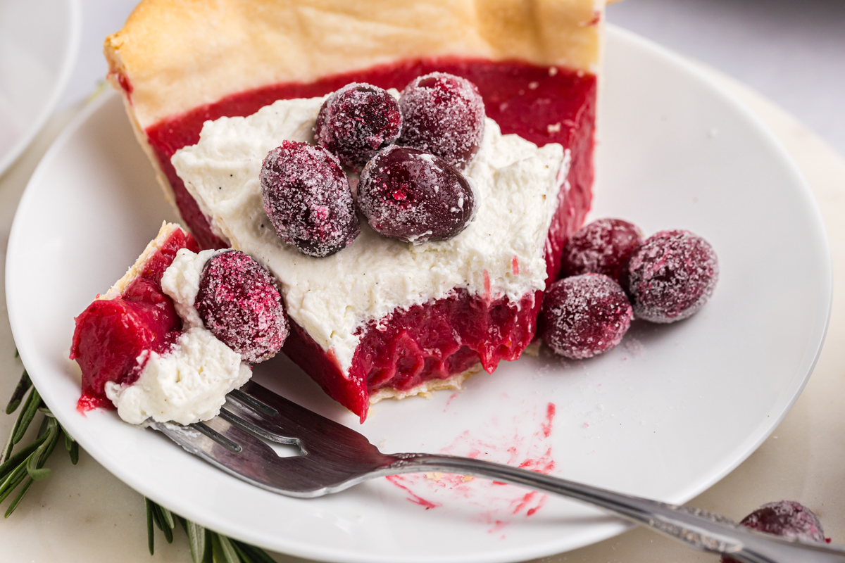 close up of bite taken out of slice of cranberry pie