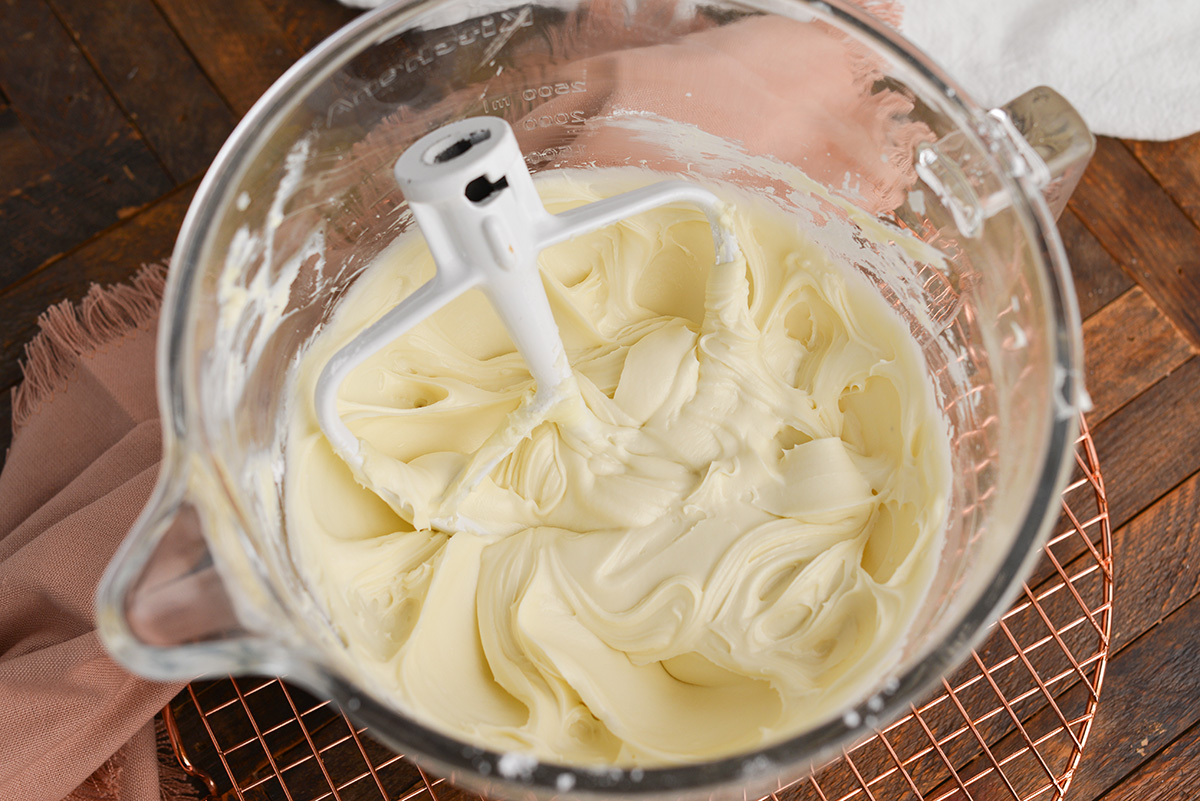 angled shot of cream cheese frosting in mixer bowl