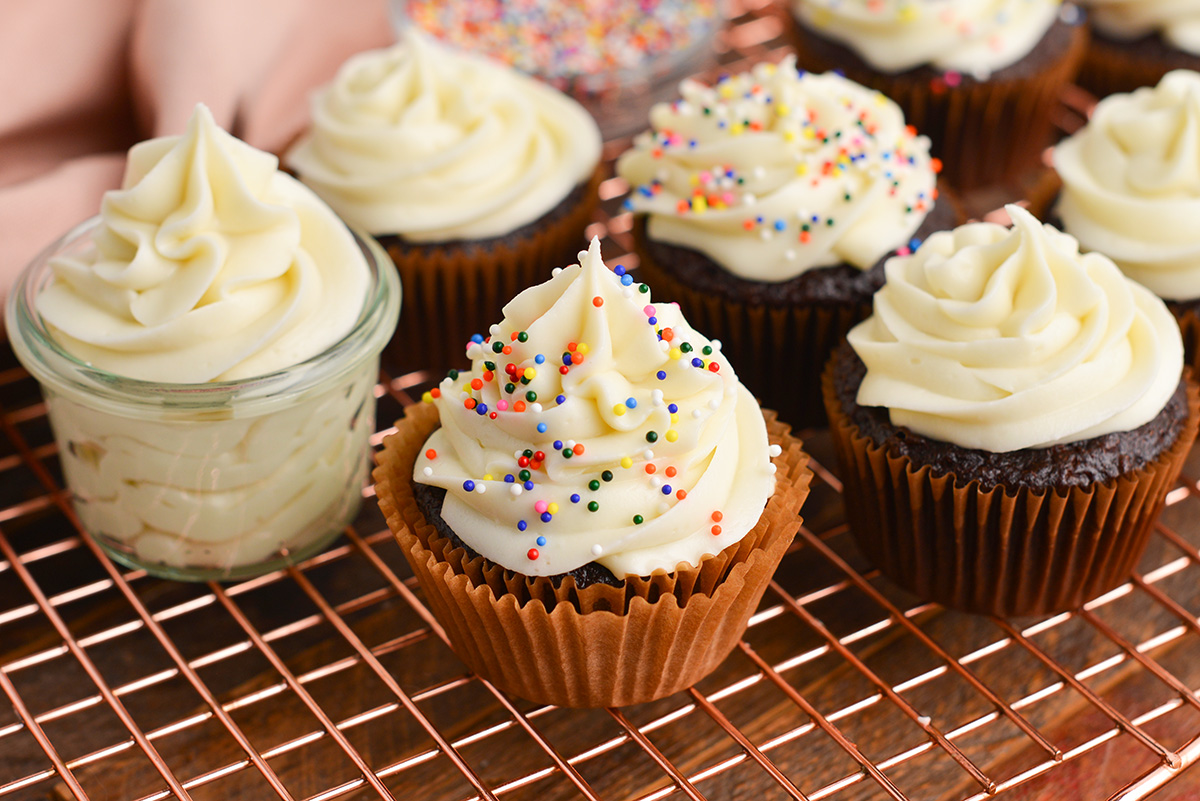 angled shot of chocolate cupcakes topped with cream cheese frosting