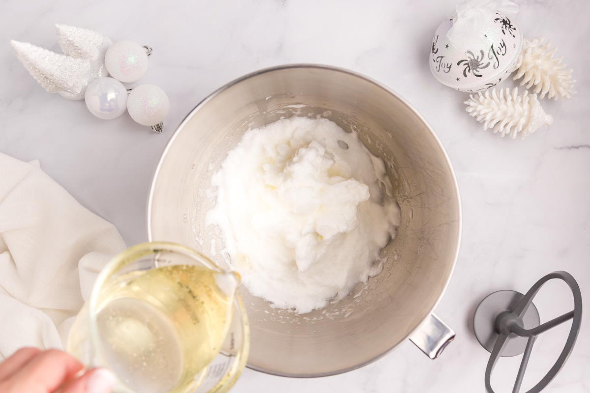 corn syrup pouring into whipped egg whites