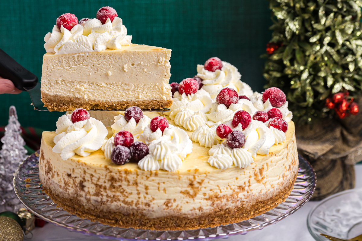 straight on shot of slice being taken out of eggnog cheesecake