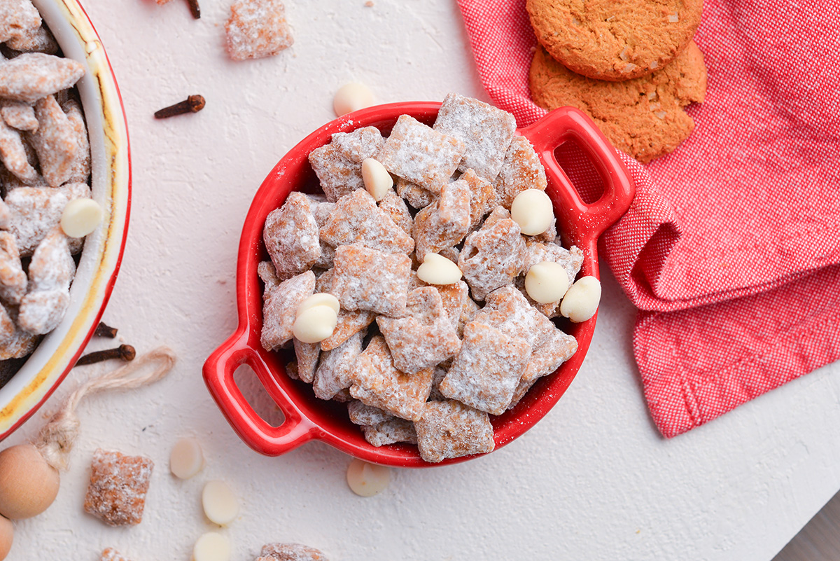 overhead shot of red bowl full of christmas puppy chow