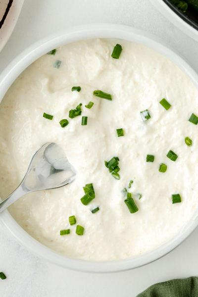 spoon in bowl of horseradish cream sauce