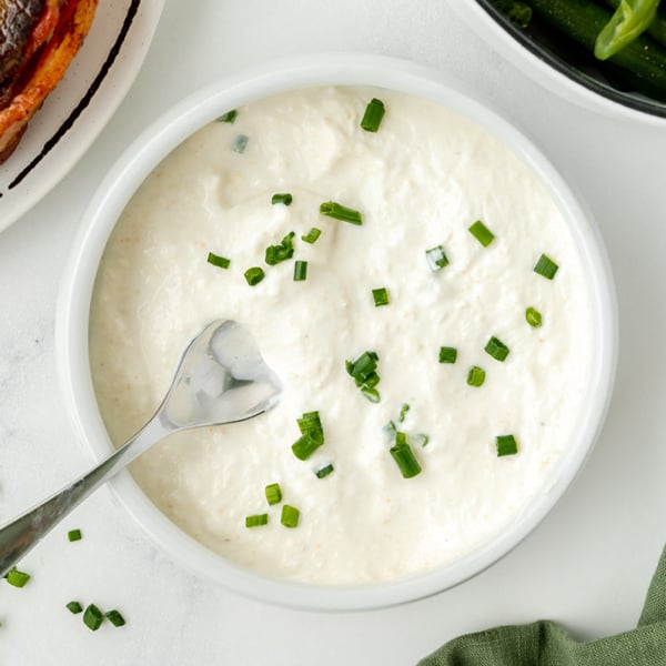 spoon in bowl of horseradish cream sauce