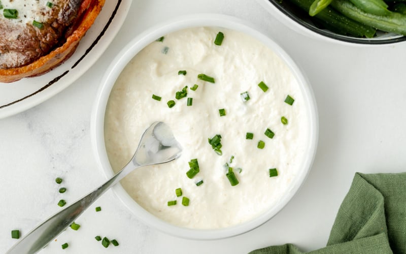 spoon in bowl of horseradish cream sauce