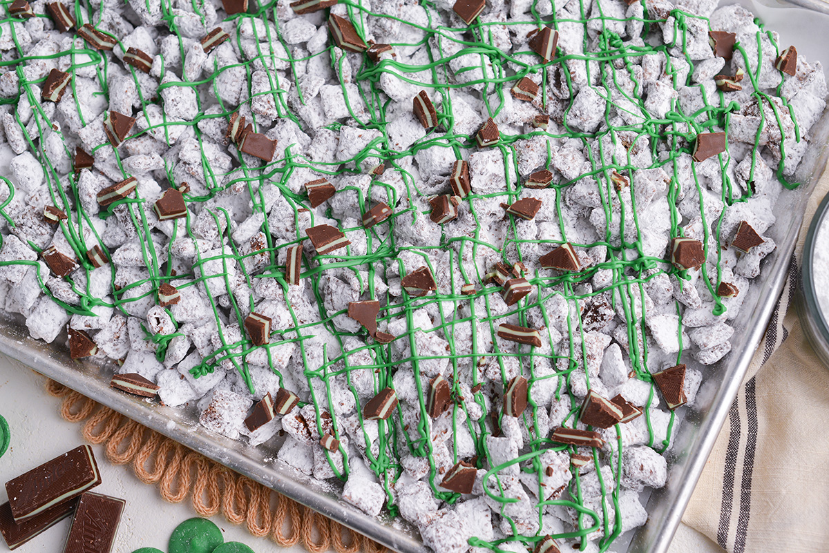 close up shot of sheet pan of mint chocolate chip muddy buddies