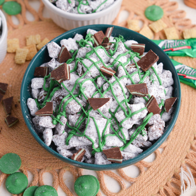 angled shot of bowl of mint chocolate chip muddy buddies