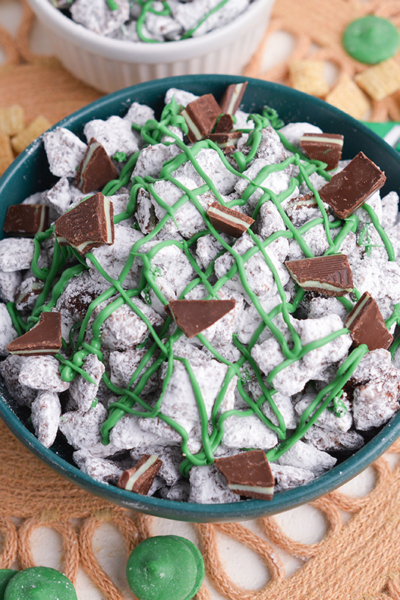 angled shot of bowl of mint chocolate chip muddy buddies