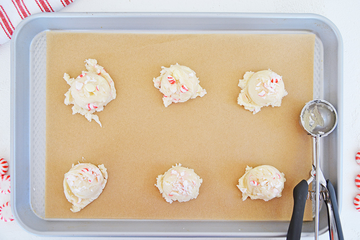 scoops of peppermint cake mix cookie dough on sheet pan